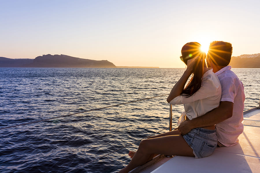 A couple looks at the wide sea from the hotel yacht