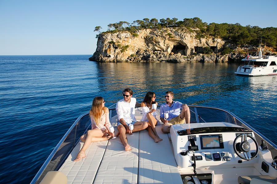 A group makes an excursion along the coast on the hotel yacht of Portals Hills